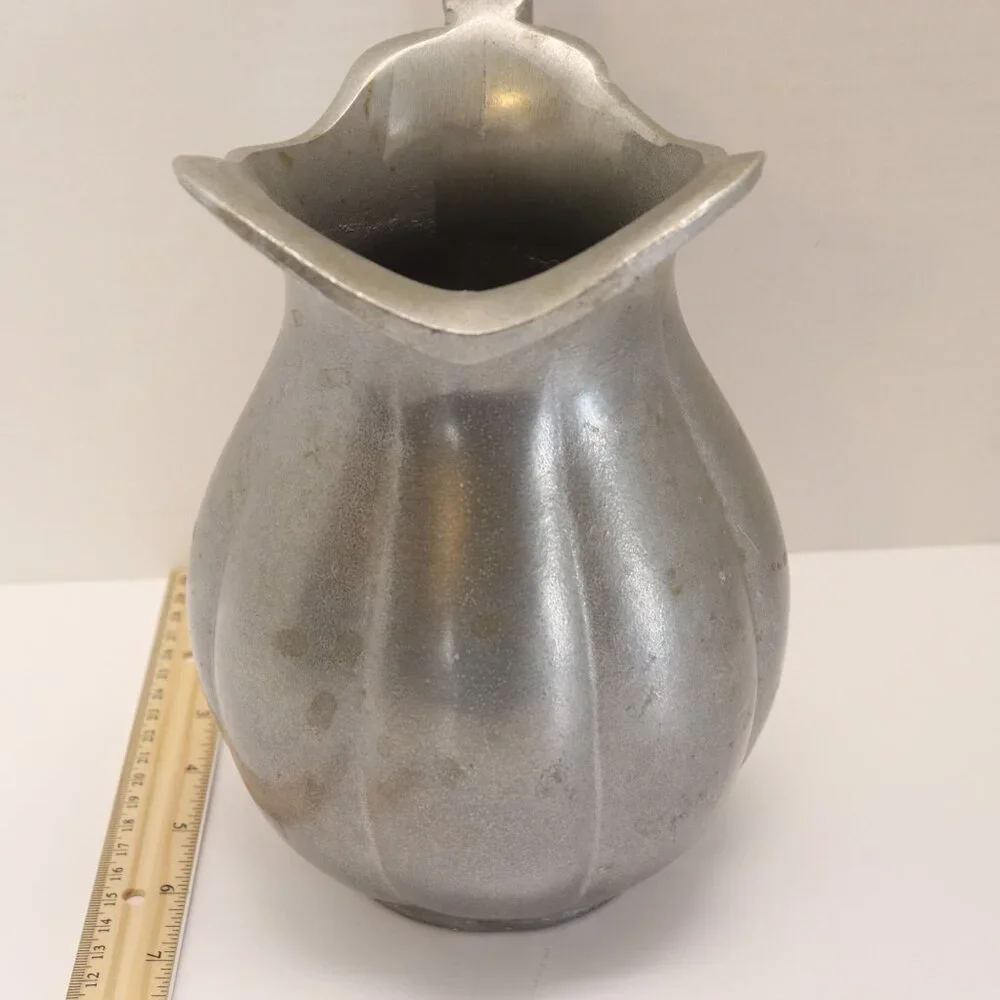 A Heavy Pewter Water Pitcher Pre Owner with some signs of wear